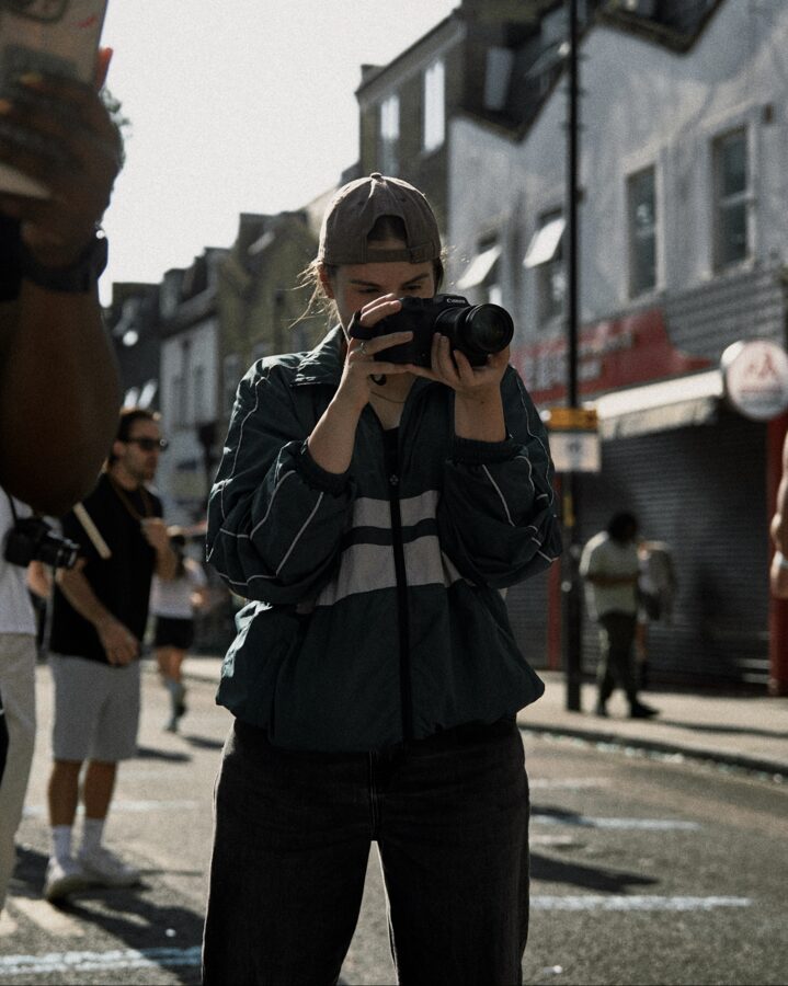 Ana filming on a London street during a race